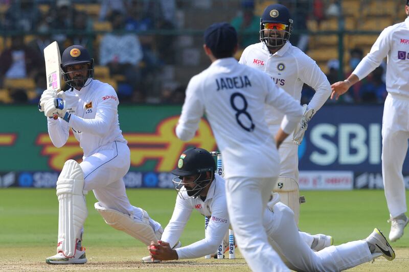 India's Hanuma Vihari takes the catch to dismiss Sri Lanka batter Dhananjaya de Silva for four. AFP