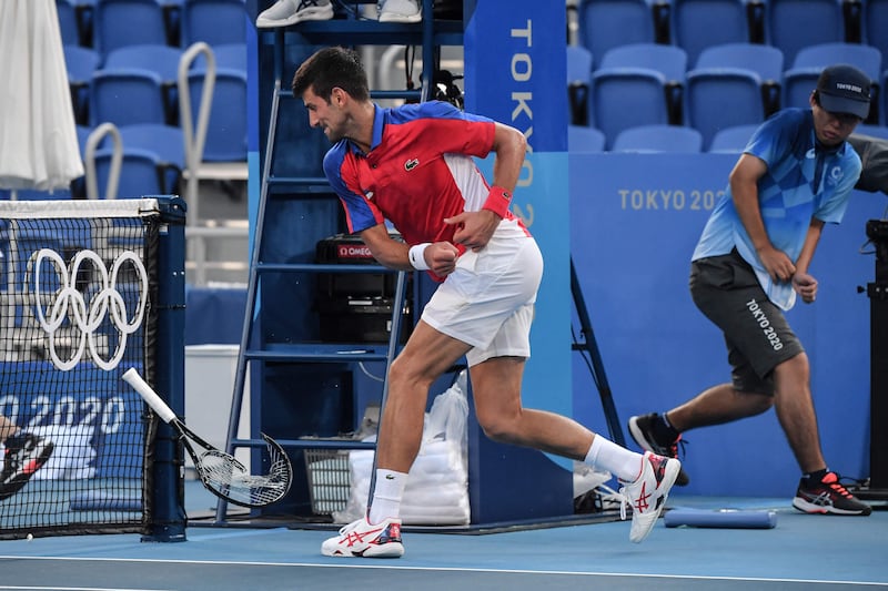Novak Djokovic smashes his racket during his Tokyo 2020 Olympic Games bronze medal match against Spain's Pablo Carreno Busta.