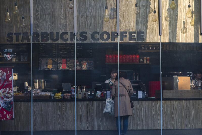 A customer stands at the counter of a Starbucks Corp. store in the Shibuya district of Tokyo, Japan, on Thursday, Nov. 16, 2017. Japan’s economy grew for a seventh straight quarter, its longest expansion since 2001, as a recovery in exports and rising business investment offset a decline in consumer spending. Photographer: Keith Bedford/Bloomberg