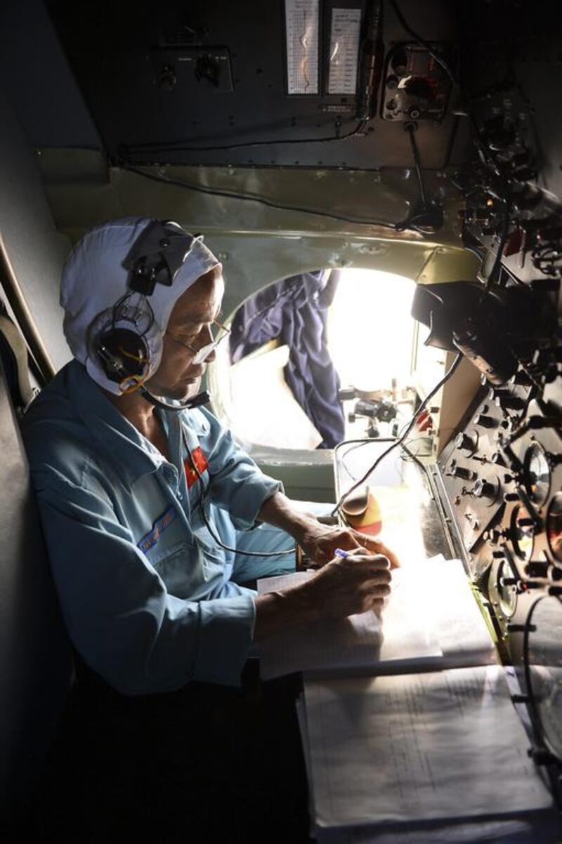 A Vietnamese Air Force officer in a search and rescue aircraft takes notes as he searches for a missing Malaysia Airlines plane, 250km from Vietnam and 190km from Malaysia. Reuters