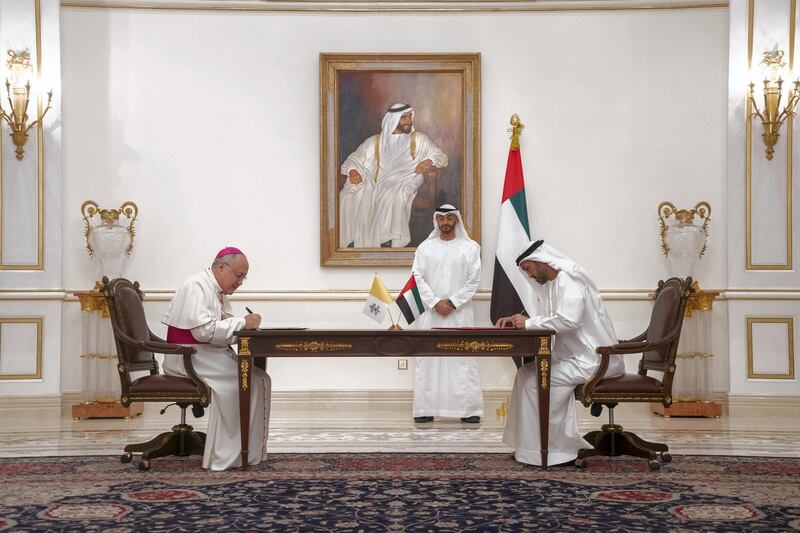 ABU DHABI, UNITED ARAB EMIRATES - November 18, 2019: HH Sheikh Mohamed bin Zayed Al Nahyan, Crown Prince of Abu Dhabi and Deputy Supreme Commander of the UAE Armed Forces (C) witnesses a signing of a collaborative declaration on global health, at the Sea Palace. Seen signing HE Mohamed Mubarak Al Mazrouei, Undersecretary of the Crown Prince Court of Abu Dhabi (R) and His Grace Archbishop Francisco Montecillo Padilla, personal envoy of His Holiness Pope Francis (L).

( Rashed Al Mansoori / Ministry of Presidential Affairs )
---