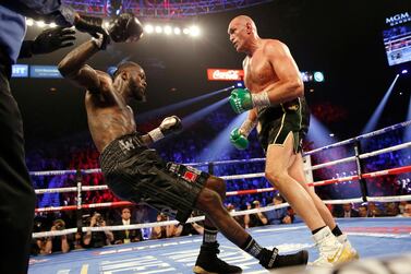 Tyson Fury knocks down Deontay Wilder on his way to winning the WBC heavyweight crown with a seventh round stoppage. Reuters