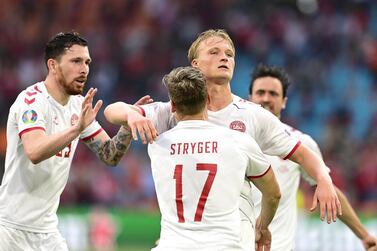 epa09303601 Kasper Dolberg (C-R) of Denmark celebrates with teammates after scoring the 2-0 lead during the UEFA EURO 2020 round of 16 soccer match between Wales and Denmark in Amsterdam, Netherlands, 26 June 2021. EPA/Olaf Kraak / POOL (RESTRICTIONS: For editorial news reporting purposes only. Images must appear as still images and must not emulate match action video footage. Photographs published in online publications shall have an interval of at least 20 seconds between the posting.)