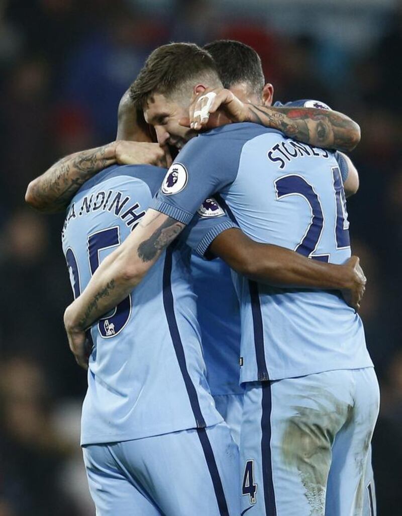 Manchester City's John Stones celebrates with Fernandinho and Aleksandar Kolarov after the game. Peter Nicholls / Reuters