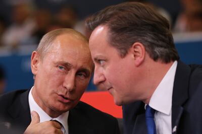Russian President Vladimir Putin watches a judo match with David Cameron in 2012. Getty Images