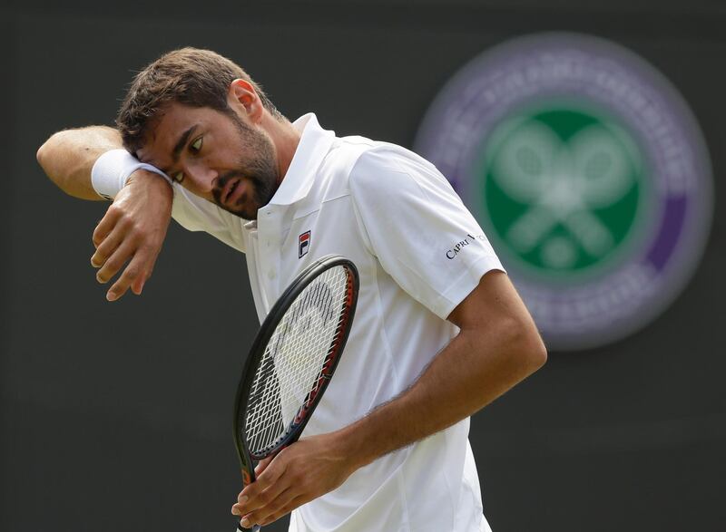 Marin Cilic of Croatia wipes his face during the men's singles match against Guido Pella of Argentina on the fourth day at the Wimbledon Tennis Championships in London, Thursday July 5, 2018. (AP Photo/Kirsty Wigglesworth)
