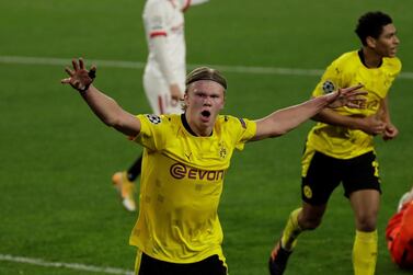 epa09019663 Borussia Dortmund's striker Erling Haaland celebrates after scoring the 1-2 lead during the first leg of the UEFA Champions League round of 16 soccer match between Sevilla FC and Borussia Dortmund held at Sanchez Pzijuan stadium in Seville, southern Spain, 17 February 2021. EPA/Julio Munoz