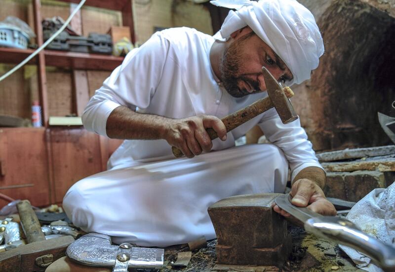 Abu Dhabi, United Arab Emirates, July 23, 2019.  VB:  Photo project at the Heritage Village, Corniche.  Local craftsworkers conduct workshops in traditional metalwork, pottery, glass blowing and Arabic cloak making. --  Abdul Rahim, from Yemen has been doing steel and silver works for over 20 years now.
Victor Besa/The National
Section:  NA
Reporter: