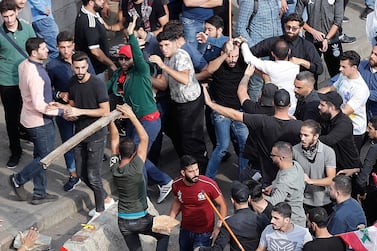 Anti-government protesters and Hezbollah supporters clash near the government palace in downtown Beirut on October 25, 2019. AP Photo