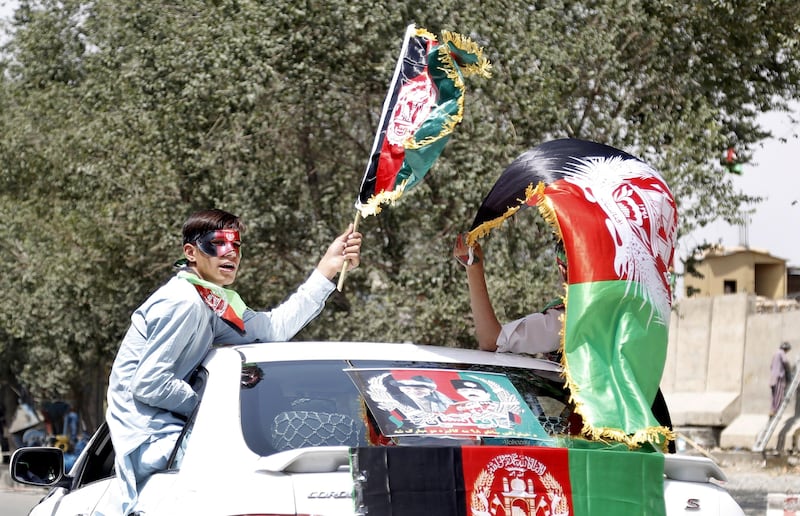 Afghans wave flags from a car as they celebrate the Independence Day in Kabul, Afghanistan. Afghanistan celebrates the 98th anniversary of its independence from British rule on 19 August. Hedayatullah Amid / EPA.