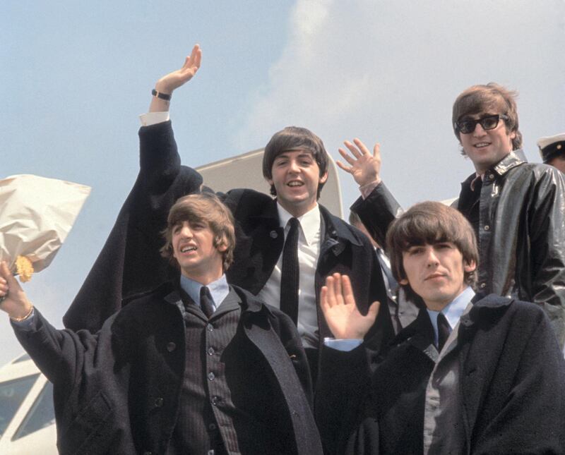 2nd July 1964:  The Beatles (from left to right, John Lennon (1940 - 1980), George Harrison (1943 - 2001), Paul McCartney and Ringo Starr) arrive back at London Airport after their Australian tour.  (Photo by Fox Photos/Getty Images)
