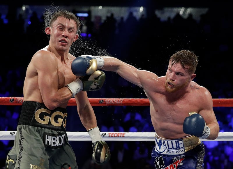 Saul 'Canelo' Alvarez, right, lands a right on Gennady Golovkin. John Locher / AP Photo