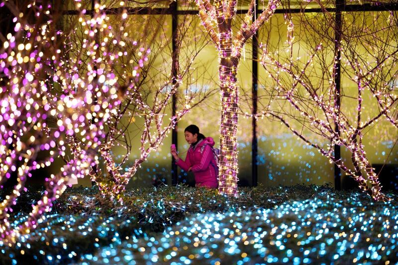 A girl walks past Christmas decorations in front of an office building in Beijing, China. Jason Lee / Reuters