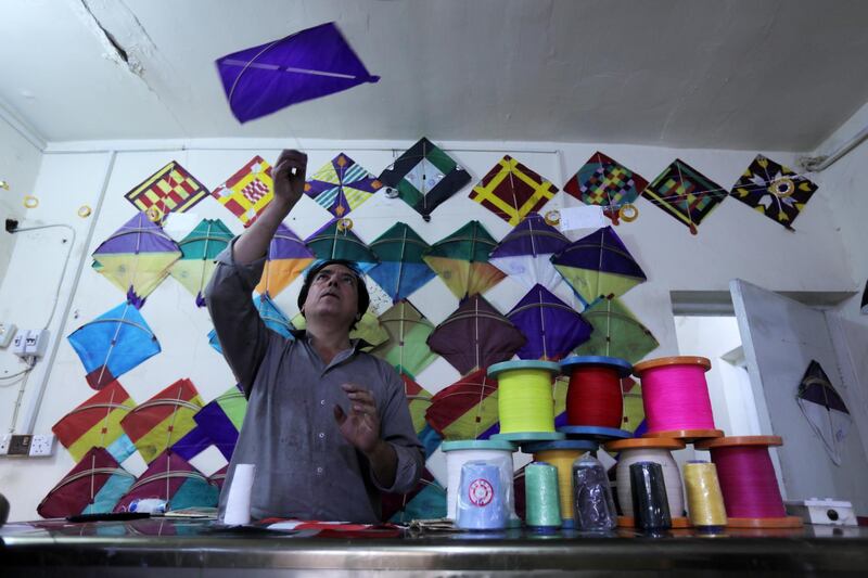 An Iraqi kite maker checks kites for a traditional game during the holy month of Ramadan, at his kite shop in Kerbala, Iraq May 12, 2019.  REUTERS