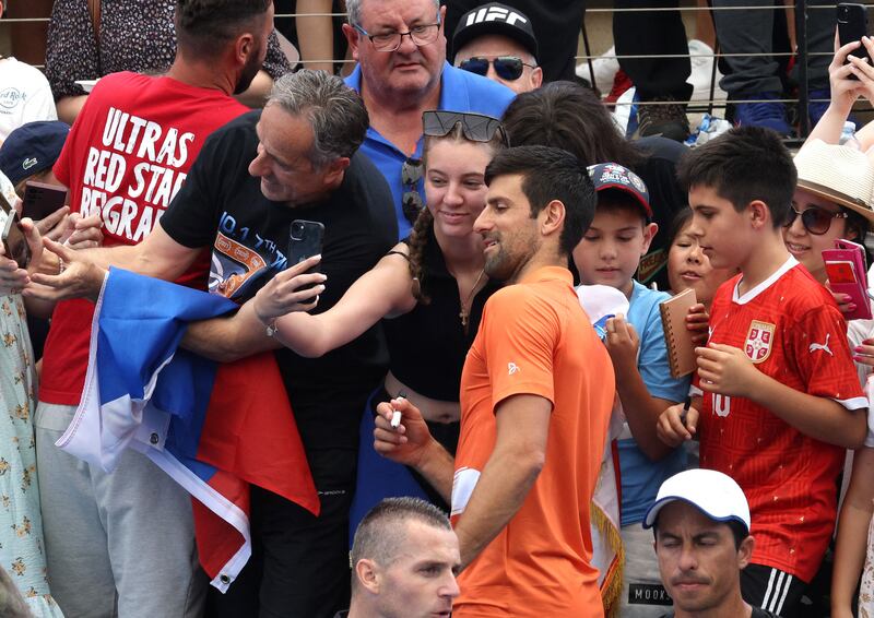 Serbia's Novak Djokovic with fans after losing his first round doubles match with Canada's Vasek Pospisil against Bosnia's Tomislav Brkic and Ecuador's Gonzalo Escobar. Reuters