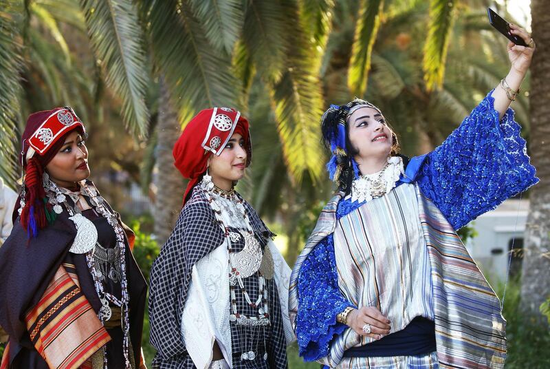 Youths take a selfie during the national day of the Libyan costume at the Martyrs Square in Tripoli, Libya. AFP