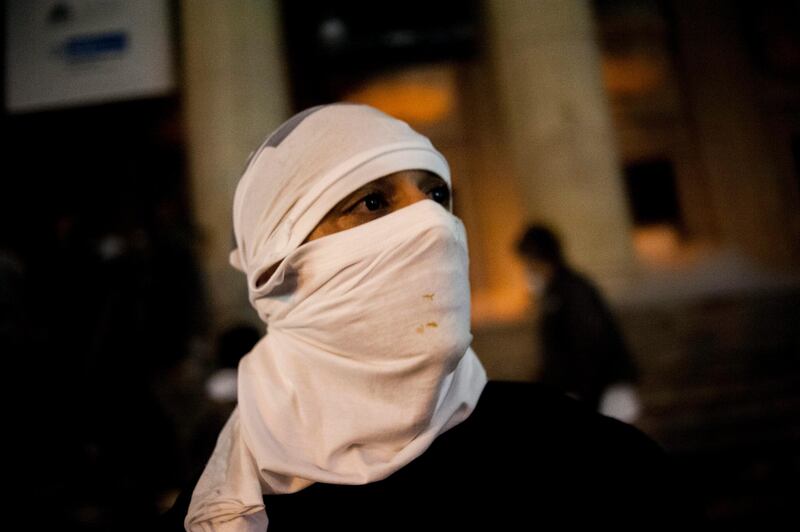 A masked protestor stands in front of the state assembly building during a protest in Rio de Janeiro, Brazil, Monday, June 17, 2013. Officers in Rio fired tear gas and rubber bullets when a group of protesters invaded the state legislative assembly and threw rocks and flares at police. Protesters massed in at least seven Brazilian cities Monday for another round of demonstrations voicing disgruntlement about life in the country, raising questions about security during big events like the current Confederations Cup and a papal visit next month. (AP Photo/Nicolas Tanner) *** Local Caption ***  Brazil Confed Cup Protests.JPEG-01bbf.jpg