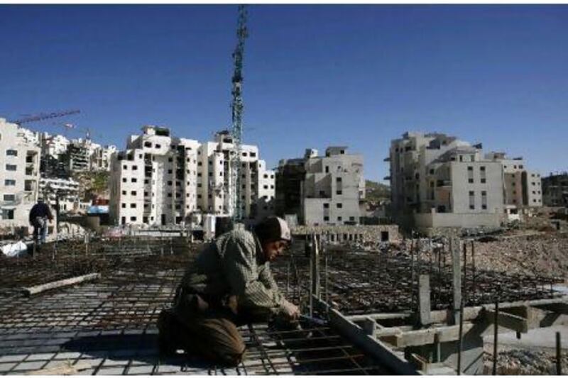 A Palestinian labourer works on a construction site at a Jewish settlement near Jerusalem. The Israeli left has largely ignored the US veto of a UN resolution condemning such settlement-building.