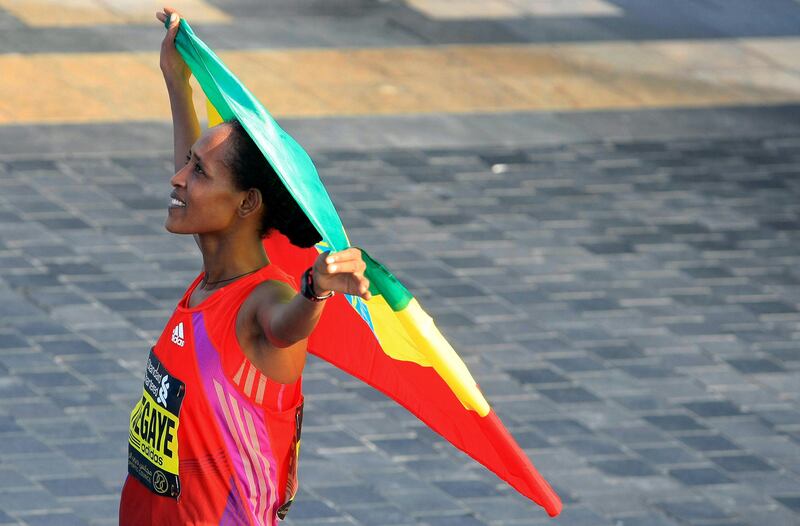 Tirfi Tsegaye Beyene of Ethiopia carries her national flag after she wins the Standard Chartered Dubai Marathon in Dubai, United Arab Emirates, Friday Jan. 25, 2013. (AP Photo) *** Local Caption ***  Mideast Emirates Dubai Marathon.JPEG-0da46.jpg