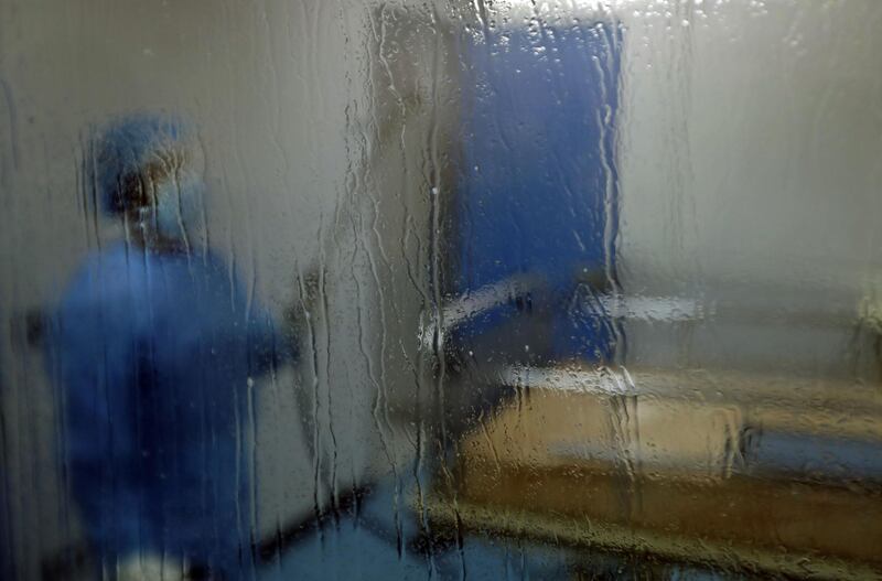 -A man disinfects an intesive care isolation room at the Rafik Hariri public hospital in the Lebanese capital Beirut.  AFP