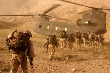 American soldiers board a Chinook helicopter during the US-led invasion of Afghanistan in 2001. Universal History Archive / Getty Images