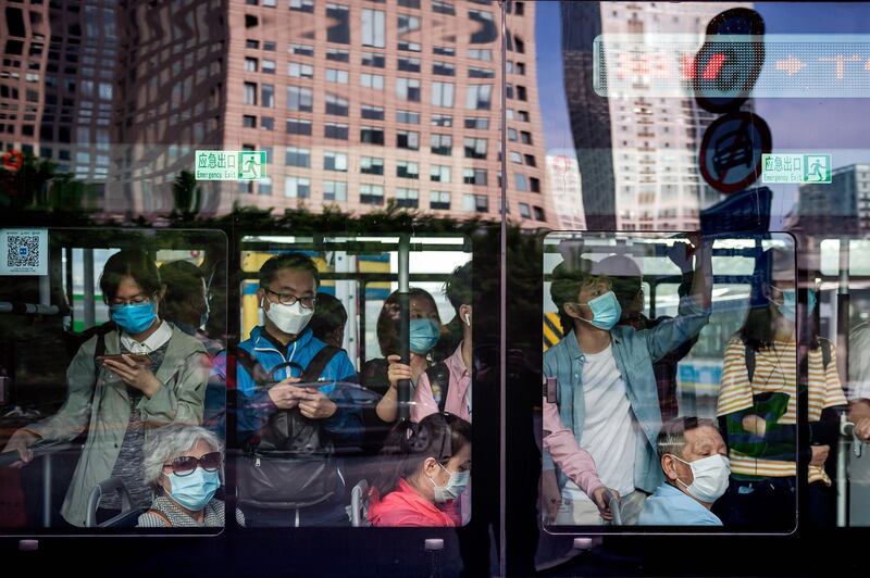 People commute on a bus during morning rush hour in Beijing.  AFP
