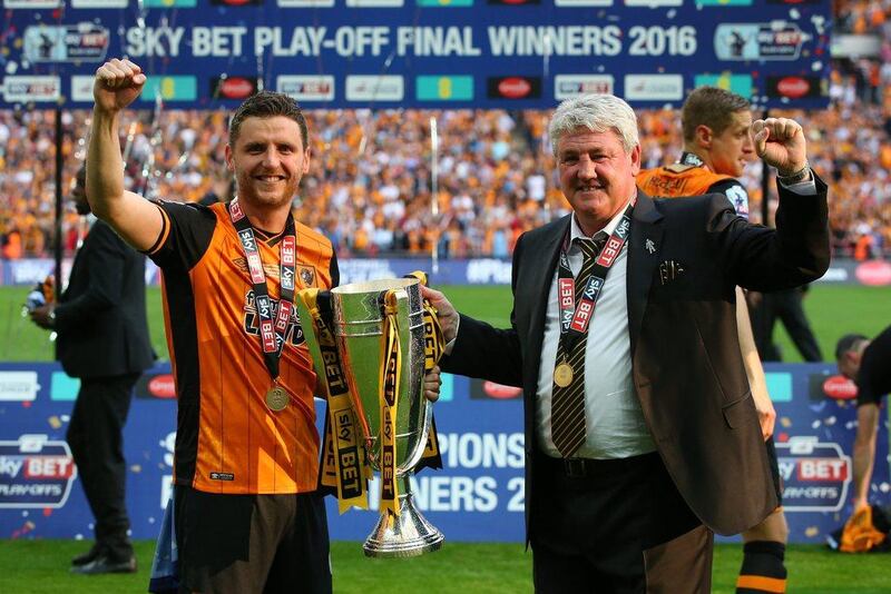 Father and son Alex Bruce, left, and Steve Bruce celebrate after Hull gained promotion back to the Premier League with a 1-0 win over Sheffield Wednesday in Saturday's Championship play-off final. Alex Livesey / Getty Images