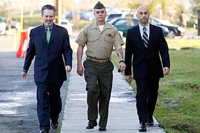 Marine Corps Staff Sgt Frank Wuterich, centre, pleaded guilty to negligent dereliction of duty for leading his troops to disregard rules of combat during the Iraq war.