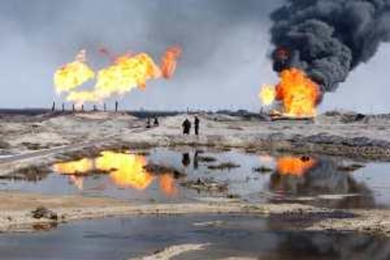 Excess gas is burned off near workers at the Rumala oil field, south of Basra, 420 km (260 miles) southeast of Baghdad, December 2, 2009. China National Petroleum Corp (CNPC) expects to begin work on Iraq's huge Rumaila oilfield imminently, the company's vice president said on Monday. Picture taken December 2, 2009. REUTERS/Atef Hassan (IRAQ ENERGY POLITICS BUSINESS) *** Local Caption ***  BAG401_IRAQ-RUMAILA_1207_11.JPG *** Local Caption ***  BAG401_IRAQ-RUMAILA_1207_11.JPG