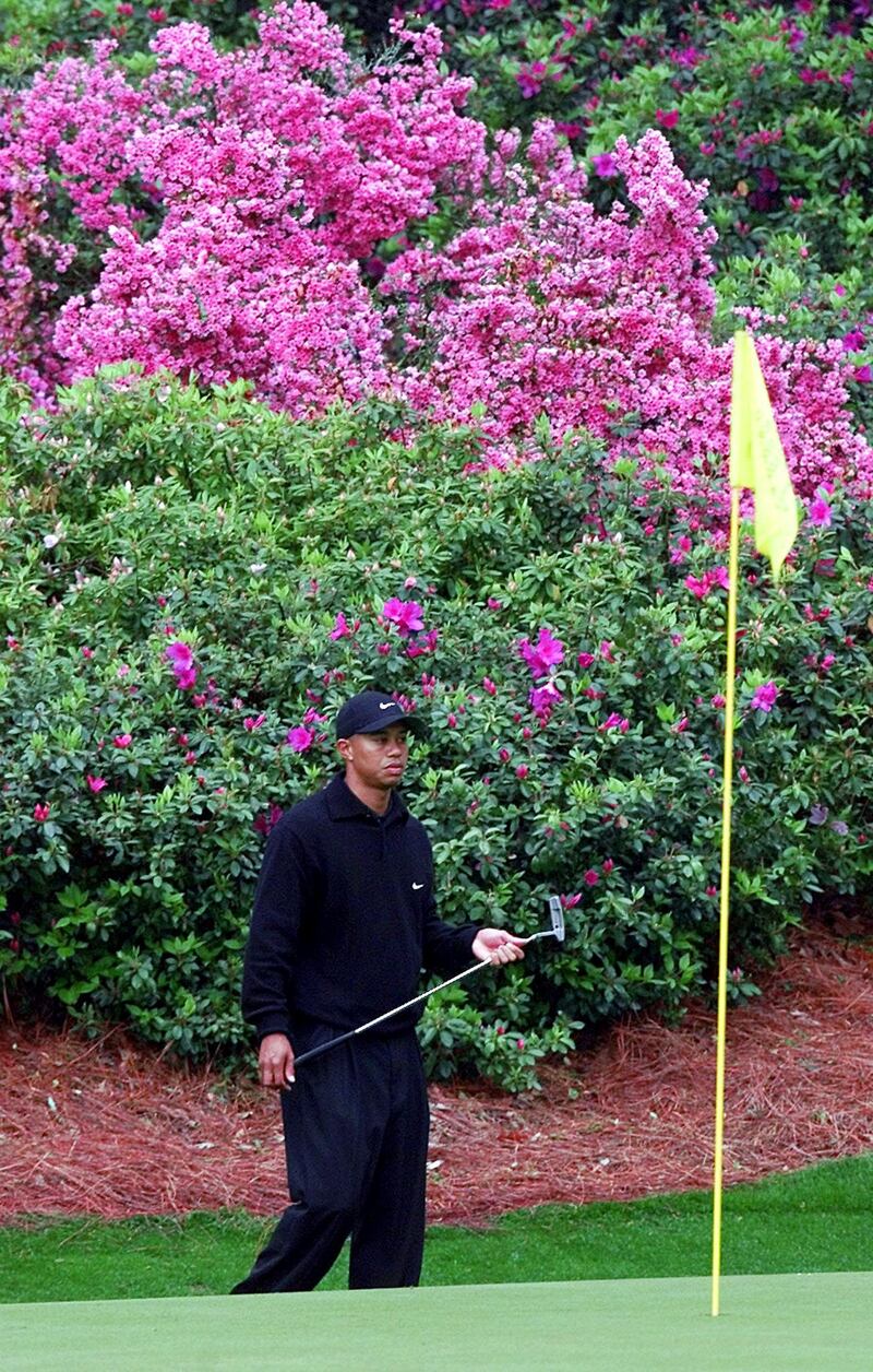 US golfers Tiger Woods watches his putt on the 12th green 04 April, 2001 during the final practice round for the 2001 Masters Golf Tournament at the Augusta National Golf Club in Augusta, Georgia. The tournament begins 05 April.   AFP PHOTO/Timothy A. CLARY (Photo by TIMOTHY A. CLARY / AFP)