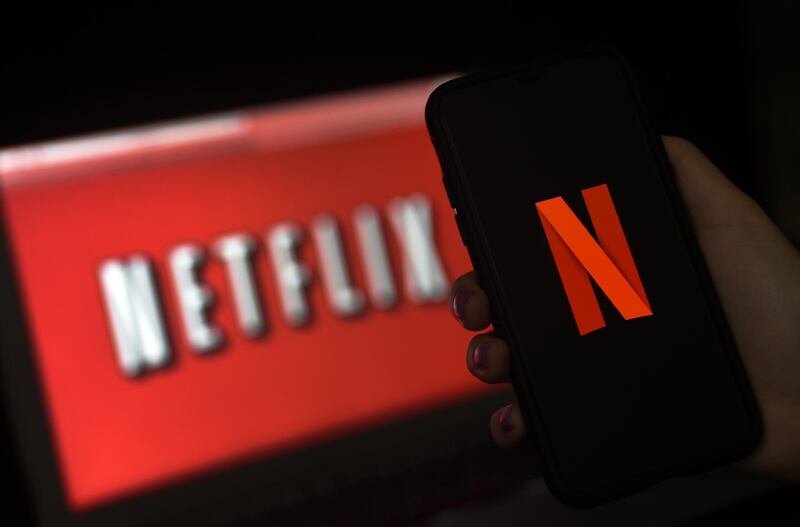 (FILES) In this file illustration photo taken on March 31, 2020 a computer screen and mobile phone display the Netflix logo in Arlington, Virginia. 
 While coronavirus has brought Hollywood to a halt, Netflix has enjoyed record success. But will the streaming giant's well-stocked slate of future shows be enough to maintain that growth? / AFP / Olivier DOULIERY

