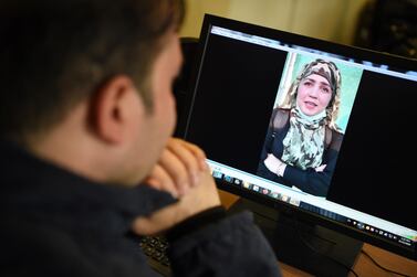 A man watches a video of Afghan woman Muzghan, who walked free from jail in September after confessing to being members of the Taliban's ultra-violent Haqqani network. AFP