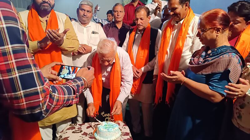 Subhash Berry, 74, the cousin of Rishi Sunak's mother Usha, cutting a cake to celebrate him becoming prime minister. Photo: Subhash Berry