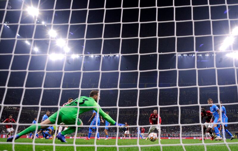 AC Milan's Rafael Leao scores their first goal past Atletico Madrid's Jan Oblak. AFP