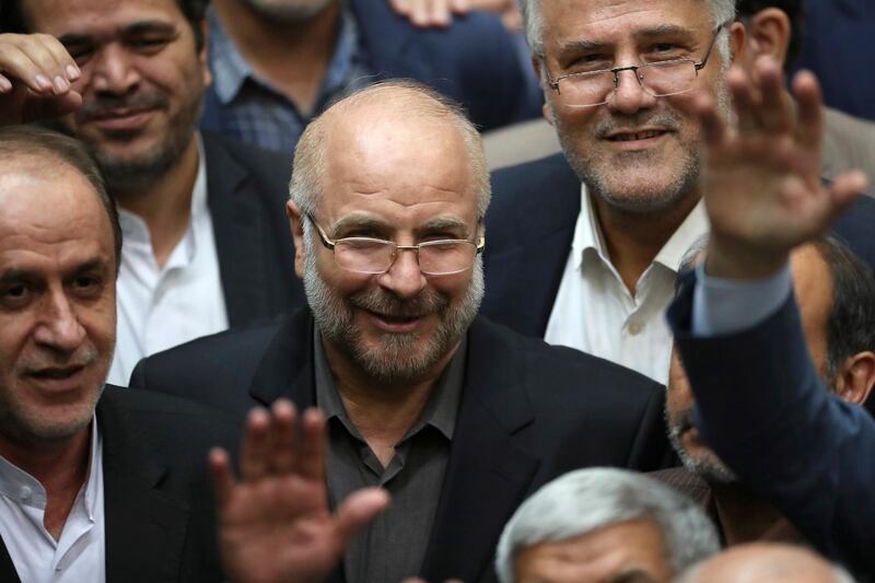 Mohammad Bagher Qalibaf, center, is surrounded by a group of lawmakers after being elected as speaker of the parliament, in Tehran, Iran, Thursday, May 28, 2020. Iran's parliament voted Thursday to elect Qalibaf, a hard-line former mayor of Tehran as the legislative body's new speaker. (AP Photo/Vahid Salemi)