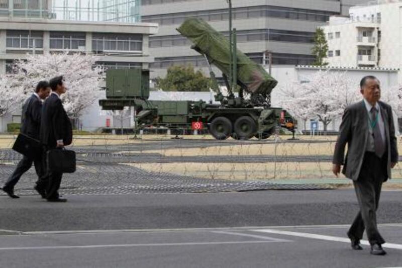Men walk near Patriot Advanced Capability-3 (PAC-3) land-to-air missiles at the Defence Ministry in Tokyo April 10, 2012. Isolated and impoverished North Korea said on Tuesday it was ready to go ahead with its proposed long-range rocket launch in a move that sparked immediate condemnation from South Korea and Russia and a plea from China, its main ally, for calm.   REUTERS/Toru Hanai (JAPAN - Tags: POLITICS MILITARY TPX IMAGES OF THE DAY) *** Local Caption ***  TOK508_KOREA-NORTH-_0410_11.JPG