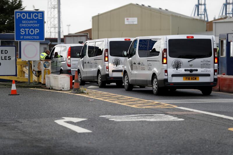 Vehicles of a funeral home arrive at the Port of Tilbury where the bodies of immigrants are being held by authorities, following their discovery in a lorry in Essex on Wednesday morning, in Tilbury, Essex, Britain October 25, 2019.  REUTERS/Peter Nicholls