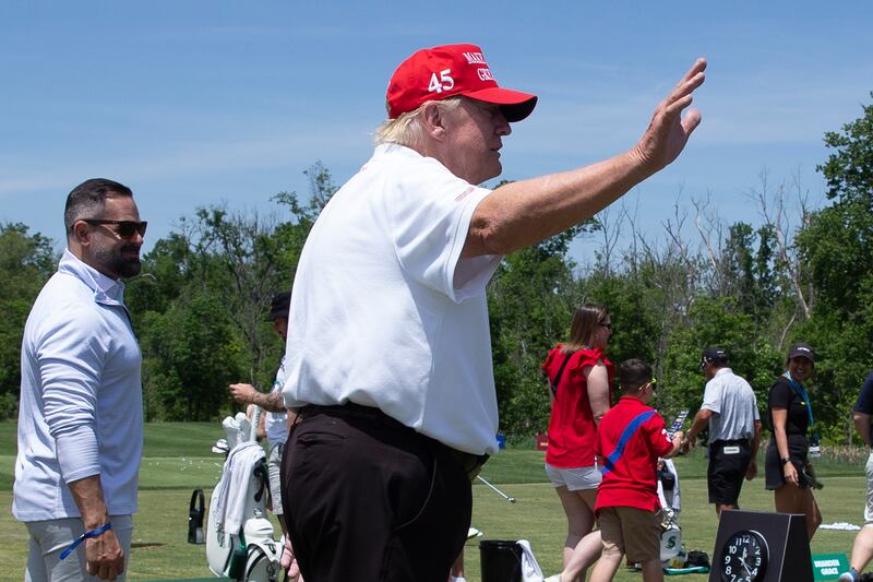 Mr Trump waves while greeting golfers at the driving range before the start of the second round of the 2023 LIV Golf DC. EPA