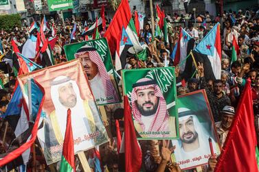 People carry portraits of Saudi and UAE leaders during a rally in support of the Arab Coalition in Yemen's southern port city of Aden on September 5, 2019. AFP