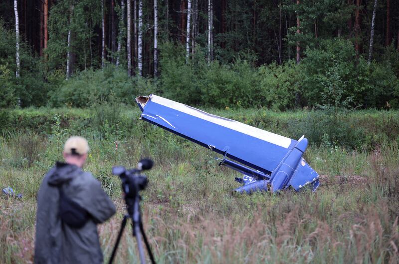 A cameraman films the wreckage of the private jet registered to Wagner Group financier Yevgeny Prigozhin near the crash site in Russia's Tver region. Reuters