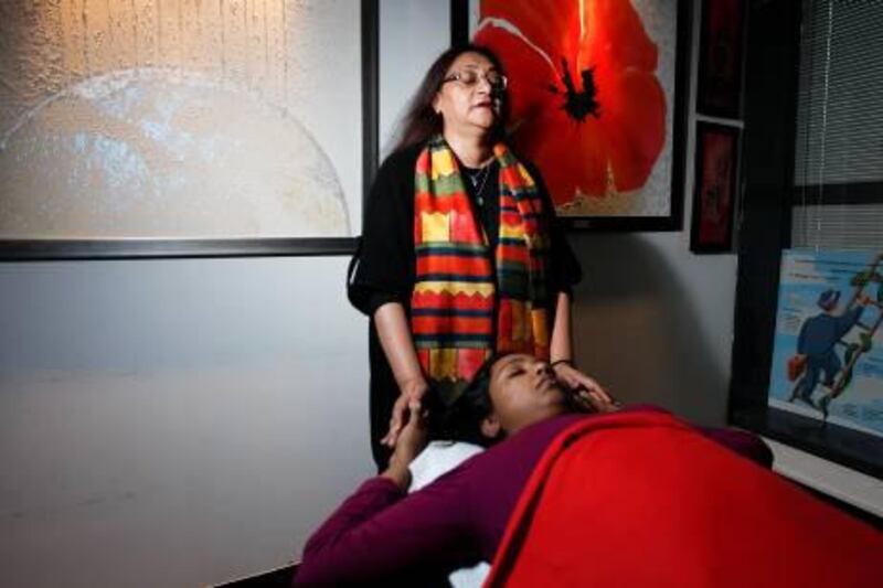 Jennifer Randive practices access consciousness on Kaveri Agasthilingam at her Bur Dubai office. Sarah Dea / The National