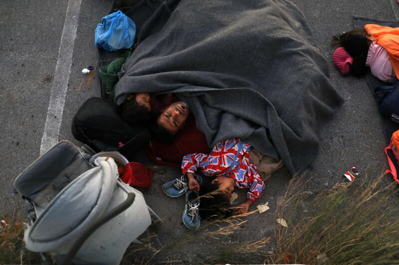 A family sleeps at a parking space, following a fire at the Moria camp for refugees and migrants on the island of Lesbos, Greece. Reuters