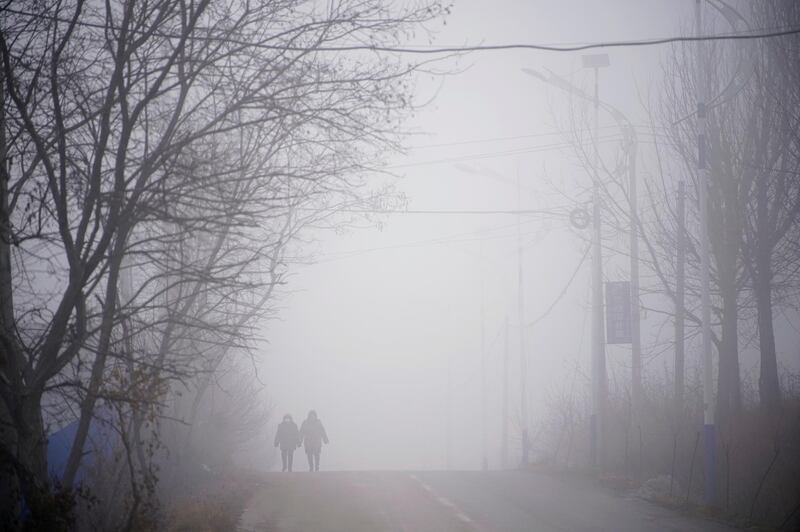 Rescue workers walk on a road leading to the Hushan gold mine, where workers are trapped underground after the January 10 explosion, in Qixia, Shandong province, China. Reuters