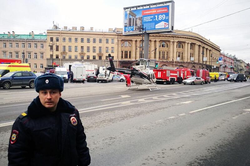 Emergency vehicles and a helicopter are seen at the entrance to the Technological Institute metro station in Saint Petersburg. Ruslan Shamukov / AFP