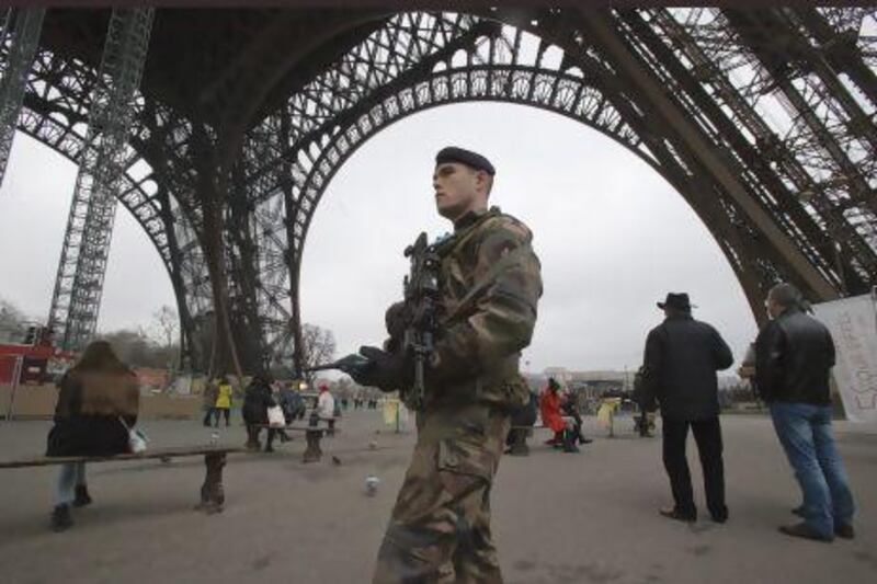 A French soldier patrols under the Eiffel Tower. France has tightened security in public buildings and transport following its military intervention against Al Qaeda-linked rebels in Mali