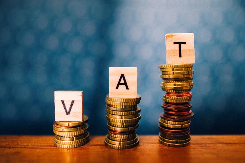 Some growing stacks of coins with the word VAT on them