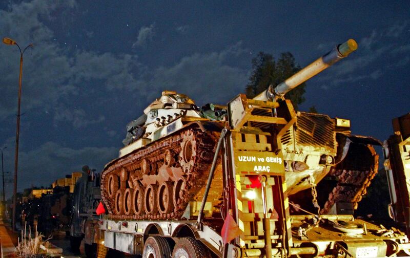 A Turkish military convoy of tanks and armoured vehicles passes through the town of Binnish reportedly heading toward the city of Idlib in Syria’s northwestern province of the same name, on February 7, 2020. Government forces yesterday seized large parts of the key highway town of Saraqeb as they pushed an offensive in the last rebel enclave in northwestern Syria, a war monitor said. Weeks of intensive aerial bombardment and a bruising ground offensive have emptied entire towns in the Idlib region and sent hundreds of thousands fleeing their homes. / AFP / Abdulaziz KETAZ
