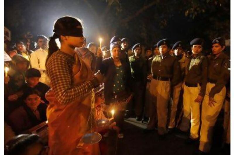 Numerous anti-rape protests, including this one in New Delhi on Sunday, do not change the fact that enduring social factors make life difficult, and dangerous, for India's women, a reader says. Altaf Qadri / AP