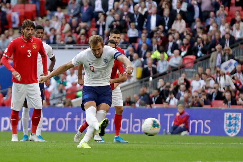 England's Harry Kane scores his side's fourth goal from the penalty spot during the Euro 2020 group A qualifying soccer match between England and Bulgaria at Wembley stadium in London, Saturday, Sept. 7, 2019. (AP Photo/Matt Dunham)
