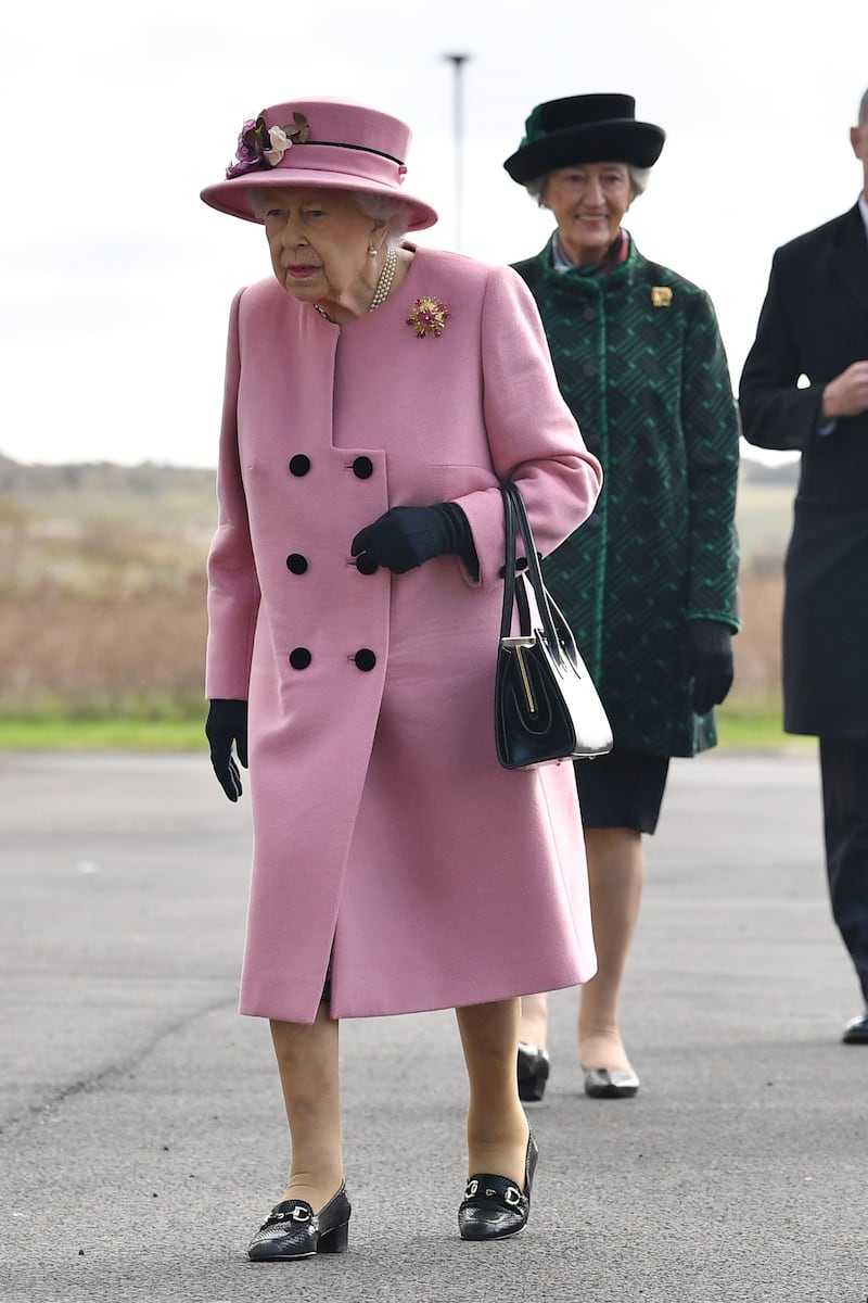 Queen Elizabeth II, wearing pink, visits the Defence Science and Technology Laboratory at Porton Down science park near Salisbury, England, on October 15, 2020. Getty Images